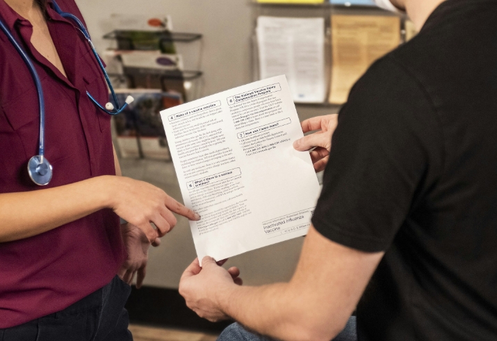 A medical professional showing a patient paperwork