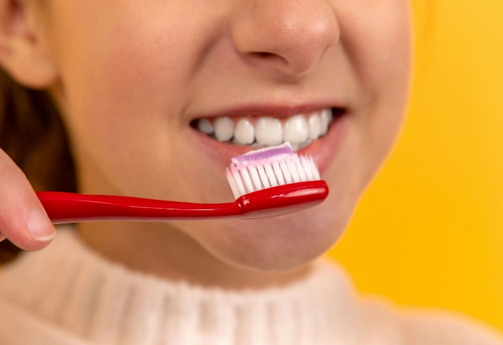 A person brushing their teeth