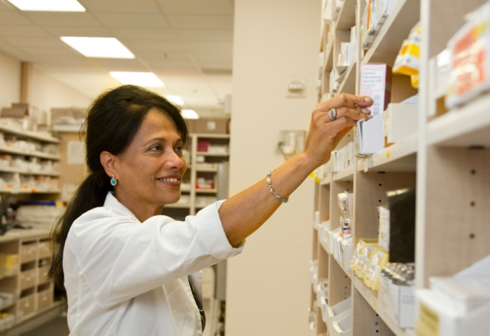 A pharmacist looking at medications